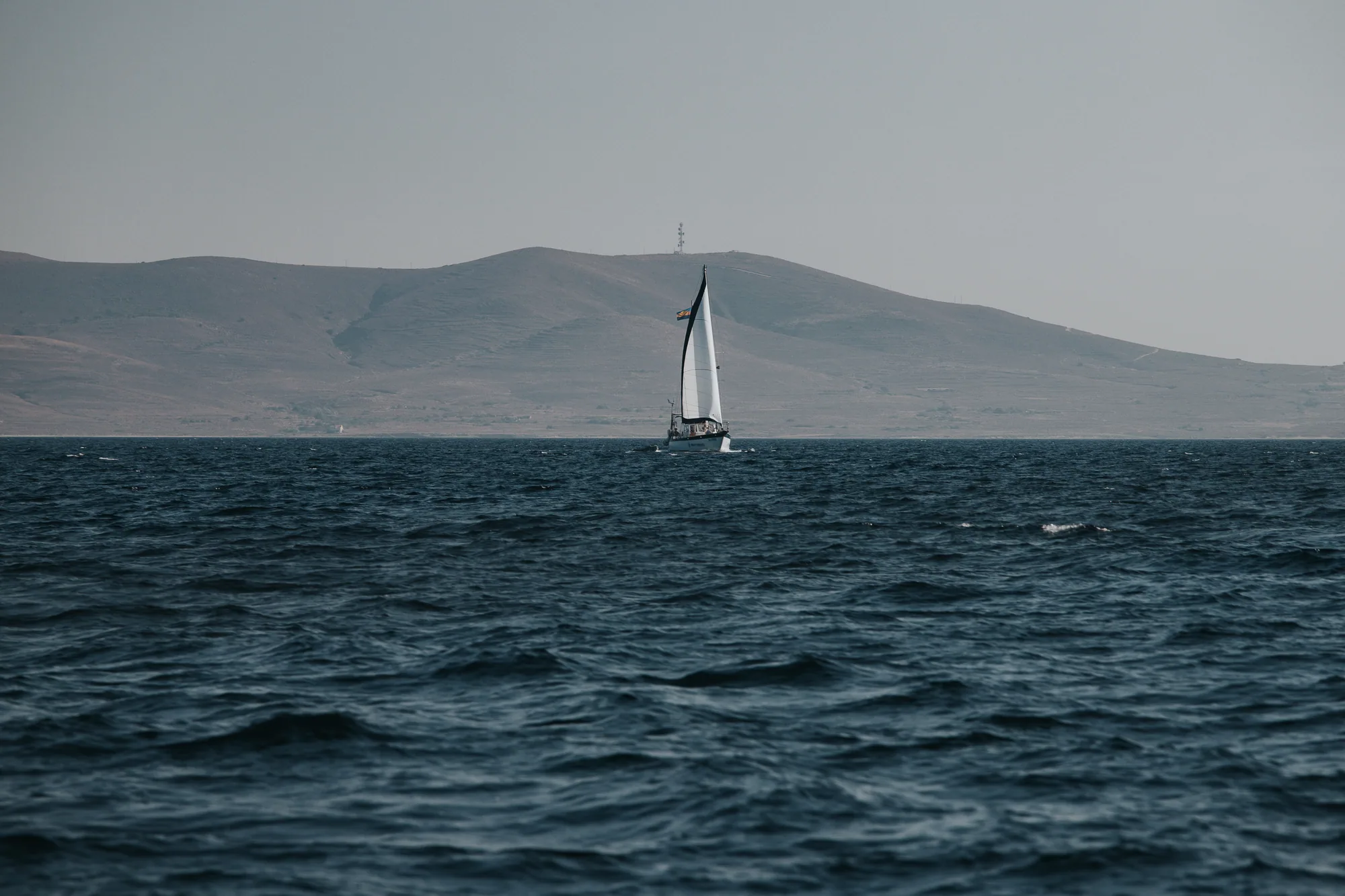 Платноходка в морето пред хълмовете на Лимнос